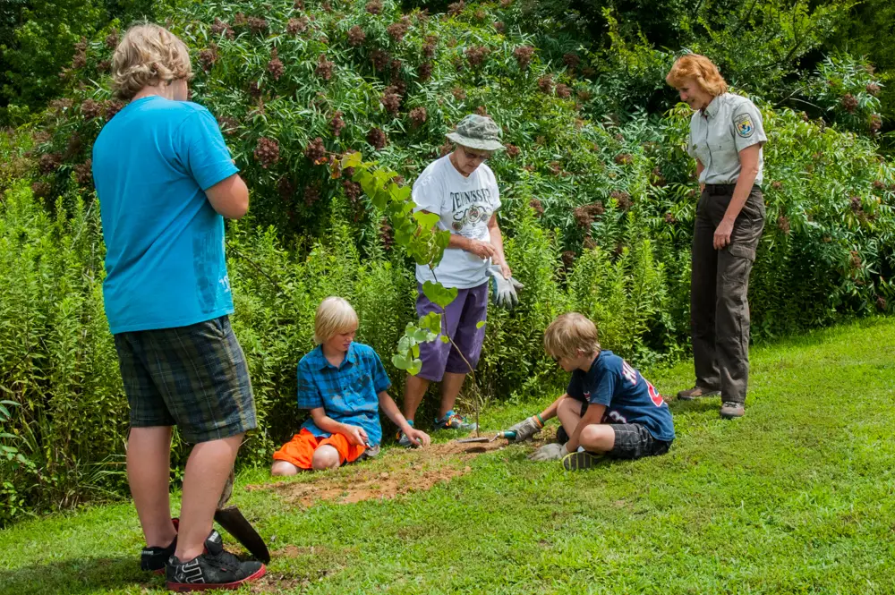 Wide shot from a recent event — Spring Festival crowd, kids at Earth Camp, or the Hummingbird Banding event